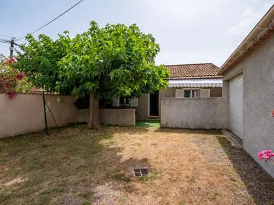 a tree in the yard of a house at Holiday Home Dami I-1 by Interhome in Santa-Lucia-di-Moriani