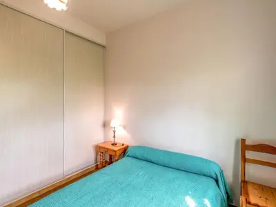 a bedroom with a bed and a lamp on a table at Holiday Home Dami I-1 by Interhome in Santa-Lucia-di-Moriani