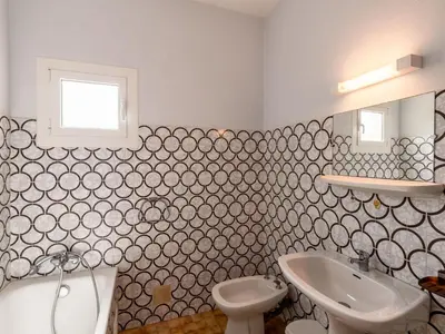 a bathroom with a toilet and a sink at Holiday Home Dami I-1 by Interhome in Santa-Lucia-di-Moriani