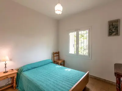 a bedroom with a bed and a window at Holiday Home Dami I-1 by Interhome in Santa-Lucia-di-Moriani