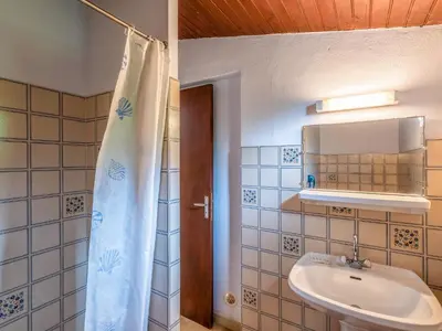 a bathroom with a sink and a shower curtain at Holiday Home Dami I-2 by Interhome in Santa-Lucia-di-Moriani