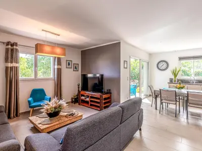 a living room with a couch and a table at Holiday Home Villa Marie-Jo by Interhome in Cervione