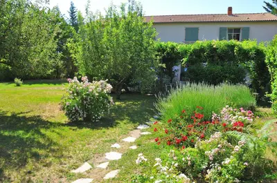 a garden with flowers and plants in front of a house at Casa Meridiana in Calacuccia