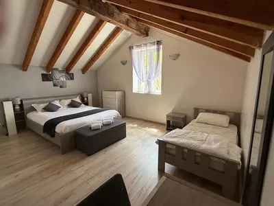 a bedroom with two beds and a window at Ferme auberge du col de la vaccia in Olivese