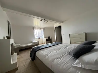 a bedroom with a large bed and a window at Ferme auberge du col de la vaccia in Olivese