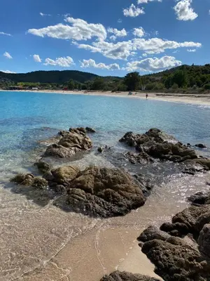 a beach with some rocks in the water at La Villa in Favone