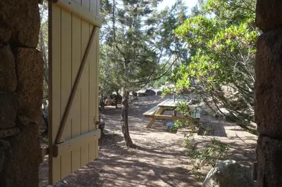 an open door of a house with a picnic table at Domaine de la Punta in Porto-Vecchio