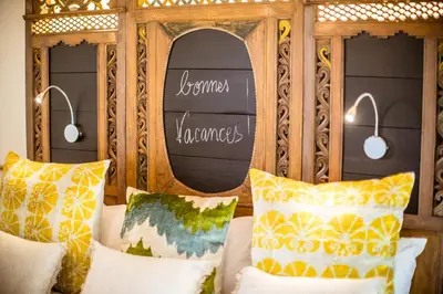 a wooden bed with pillows and a sign on it at U Capu Biancu in Bonifacio