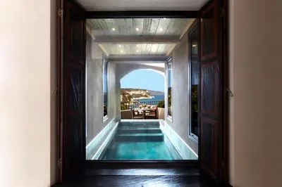 an open door to a swimming pool in a house at U Capu Biancu in Bonifacio