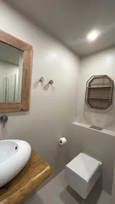 a bathroom with a sink and a toilet and a mirror at Hôtel E Tre Stelle in Bonifacio