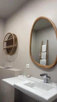 a bathroom with a white sink and a mirror at Hôtel E Tre Stelle in Bonifacio