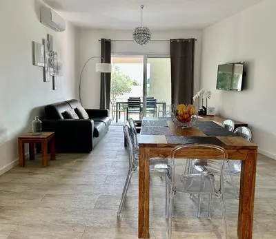 a living room with a dining table and a couch at Residence Casa Di Paoli in Porto-Vecchio