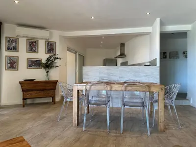 a dining room with a wooden table and chairs at Residence Casa Di Paoli in Porto-Vecchio