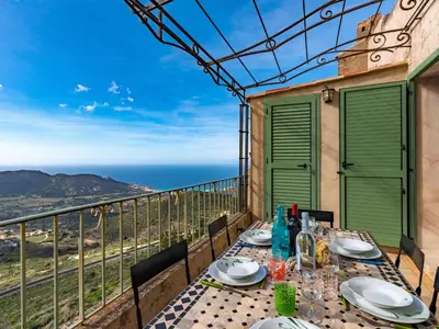 a table on the balcony with a view of the ocean at Apartment Casa Marcelli by Interhome in SantʼAntonino