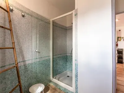 a bathroom with a glass shower with a tub at Apartment Casa Marcelli by Interhome in SantʼAntonino