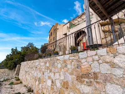 a stone wall in front of a building at Apartment Casa Marcelli by Interhome in SantʼAntonino