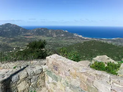 a stone wall with the ocean in the background at Apartment Casa Marcelli by Interhome in SantʼAntonino