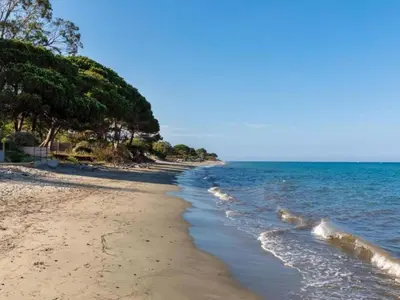 a beach with some rocks and the ocean at Apartment MB2 sans vue mer by Interhome in Moriani Plage