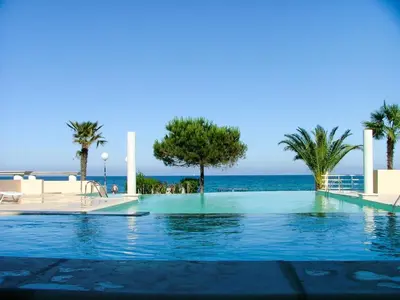 a swimming pool with the ocean in the background at Apartment MB4 piscine by Interhome in Moriani Plage