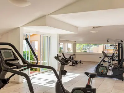 a gym with treadmills and ellipticals in a room at Apartment MB4 piscine by Interhome in Moriani Plage