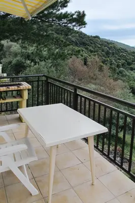 a white picnic table on a balcony with a view at Apartment Fougère by Interhome in Partinello