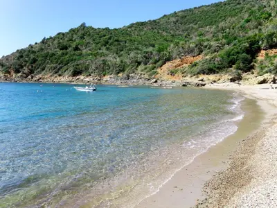 a boat in the water next to a beach at Apartment Fougère by Interhome in Partinello