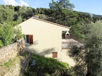 a small white house with a stone wall at Apartment Fougère by Interhome in Partinello