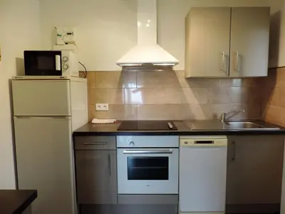 a kitchen with a white refrigerator and a sink at Apartment Fougère by Interhome in Partinello
