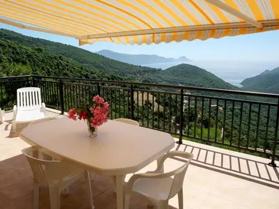 a table with a vase of flowers on a balcony at Apartment Aloes by Interhome in Partinello
