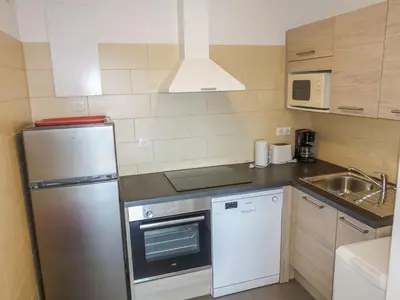 a kitchen with a stainless steel refrigerator and a sink at Apartment Camelia- Marjolène by Interhome in Partinello