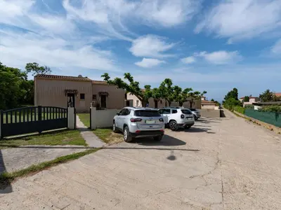a group of cars parked in a parking lot at Holiday Home La Pinède- bungalow 4 pers- by Interhome in Sagone