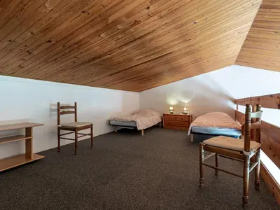 a room with two beds and a wooden ceiling at Holiday Home La Pinède- bungalow 6 pers- by Interhome in Sagone