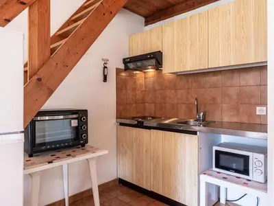 a kitchen with a sink and a microwave at Holiday Home La Pinède- bungalow 6 pers- by Interhome in Sagone