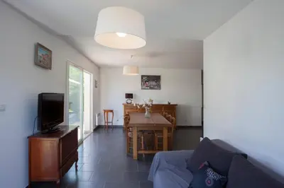 a living room with a couch and a table at Villa Jardins de la Mer in Poggio-Mezzana