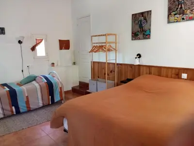 a bedroom with a bed and a window at Villa Trou Aux Biches in Oletta