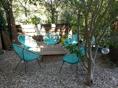 four blue chairs and a table and a tree at Villa Trou Aux Biches in Oletta