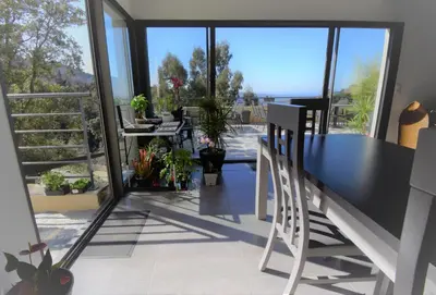 a dining room with a table and chairs on a balcony at A Casa Di Campa in Oletta