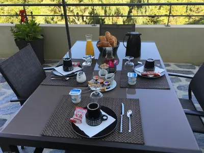 a table with a breakfast of coffee and croissants at A Casa Di Campa in Oletta