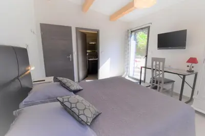 a bedroom with a bed and a desk and a window at A Casa Di Campa in Oletta