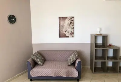a chair in a room with a picture on the wall at L'armandulina in Sagone