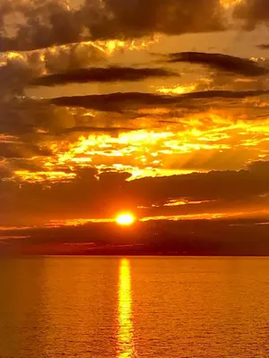 a sunset over a body of water at L'armandulina in Sagone