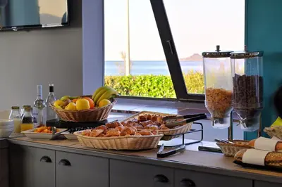 a counter with baskets of fruit and other food on it at Résidence Les Calanques in Ajaccio
