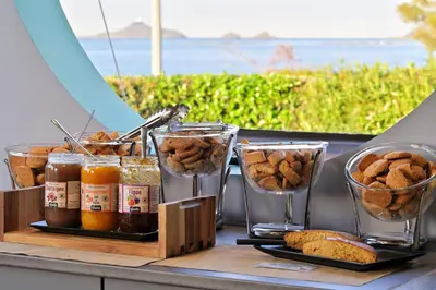 a table with two glasses of food and some bread at Résidence Les Calanques in Ajaccio