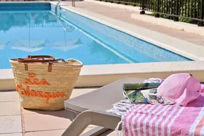 a picnic table with a basket next to a pool at Résidence Les Calanques in Ajaccio