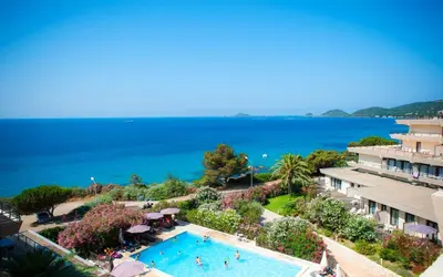 an aerial view of a resort with a swimming pool and the ocean at Résidence Les Calanques in Ajaccio