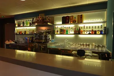 a bar with a lot of bottles and glasses at Résidence Les Calanques in Ajaccio