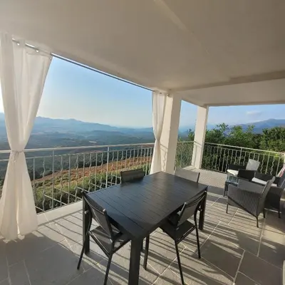 a black table and chairs on a balcony with a view at Conca d'Oro in Vallecalle