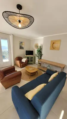 a living room with a blue couch and a table at Conca d'Oro in Vallecalle