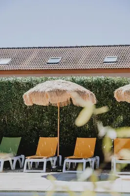 a group of lawn chairs and an umbrella at Casa Marana by Le Lido in Lucciana