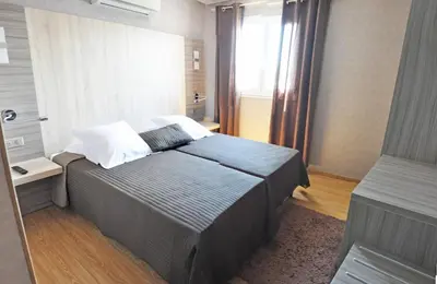 a bedroom with a large bed and a window at Casa Marana by Le Lido in Lucciana